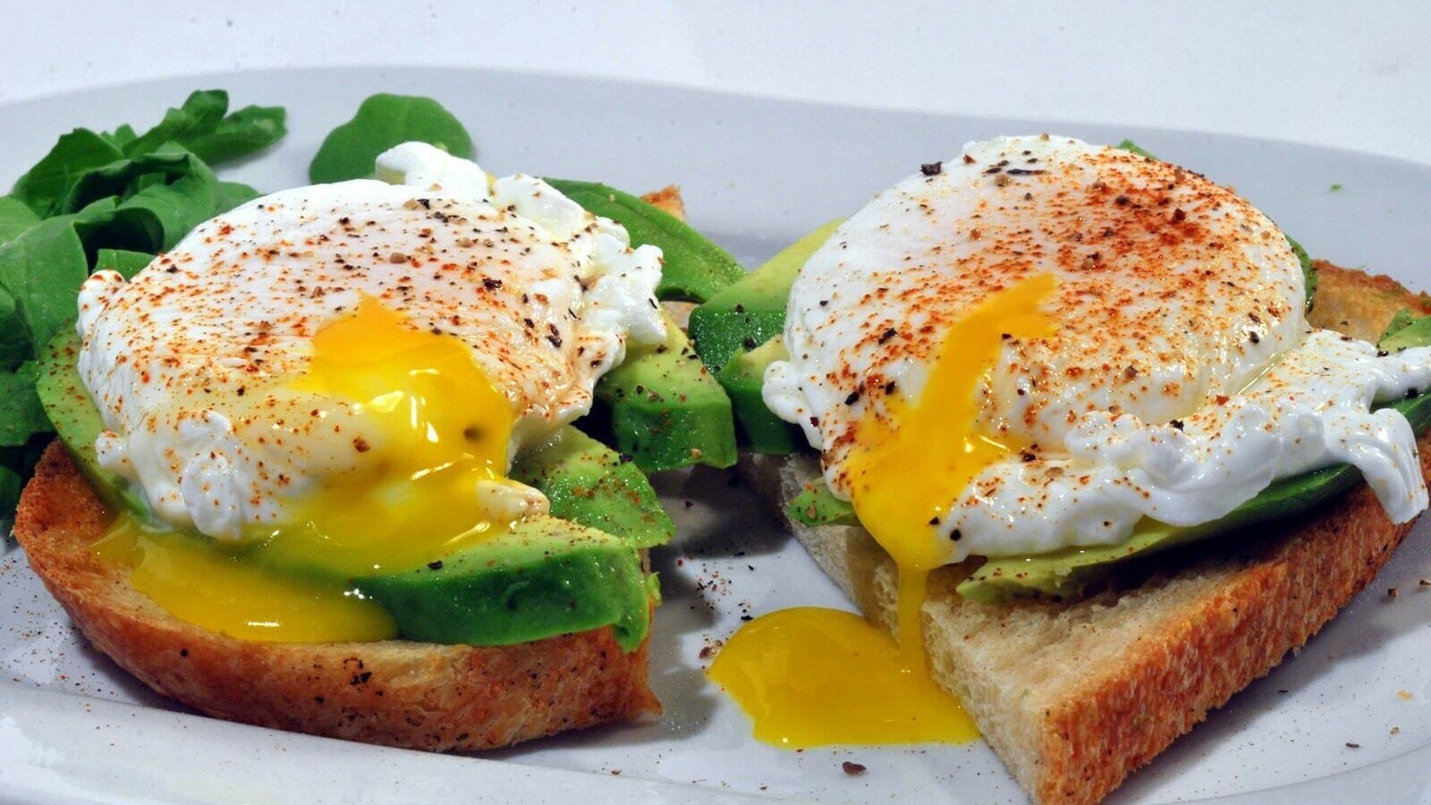 bread with egg and vegetable on white ceramic plate