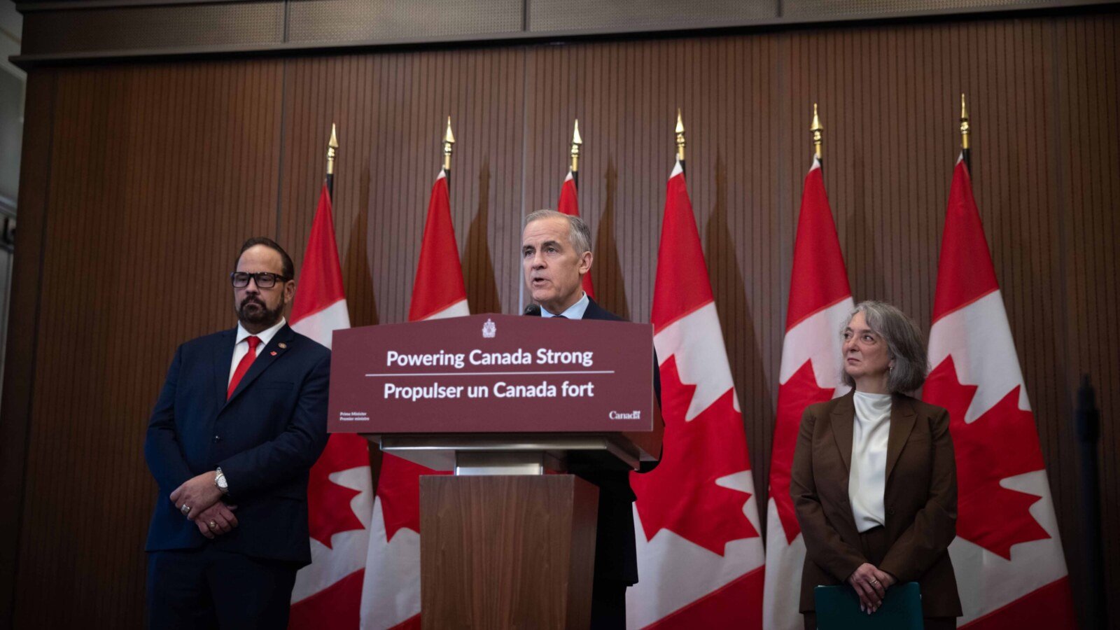 news image of Prime Minister Mark Carney speaking at a podium during AI strategy launch in Toronto