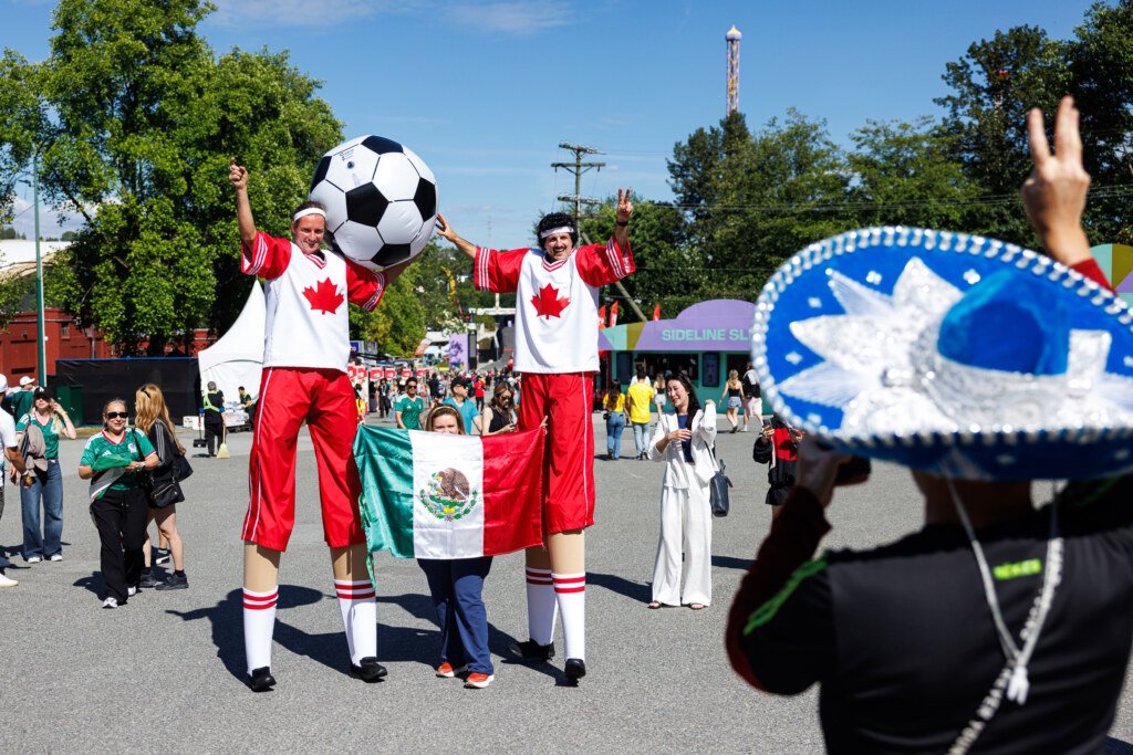 Stilt walkers entertaining crowd at FIFA Fan Festival Vancouver opening day