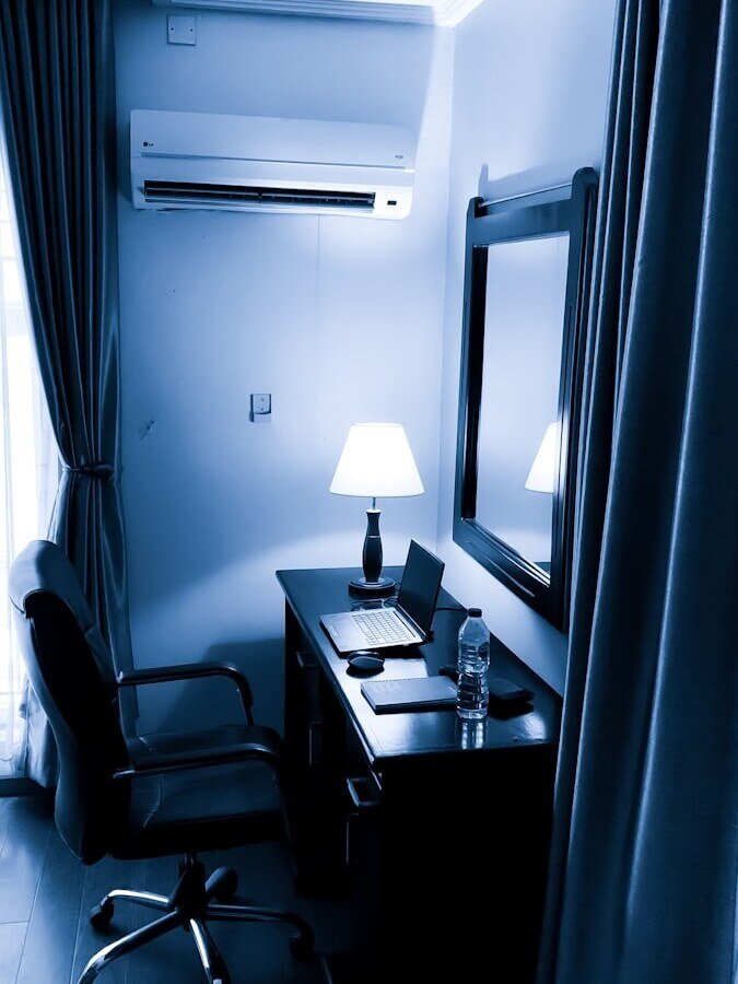 a desk with a lamp and a mirror