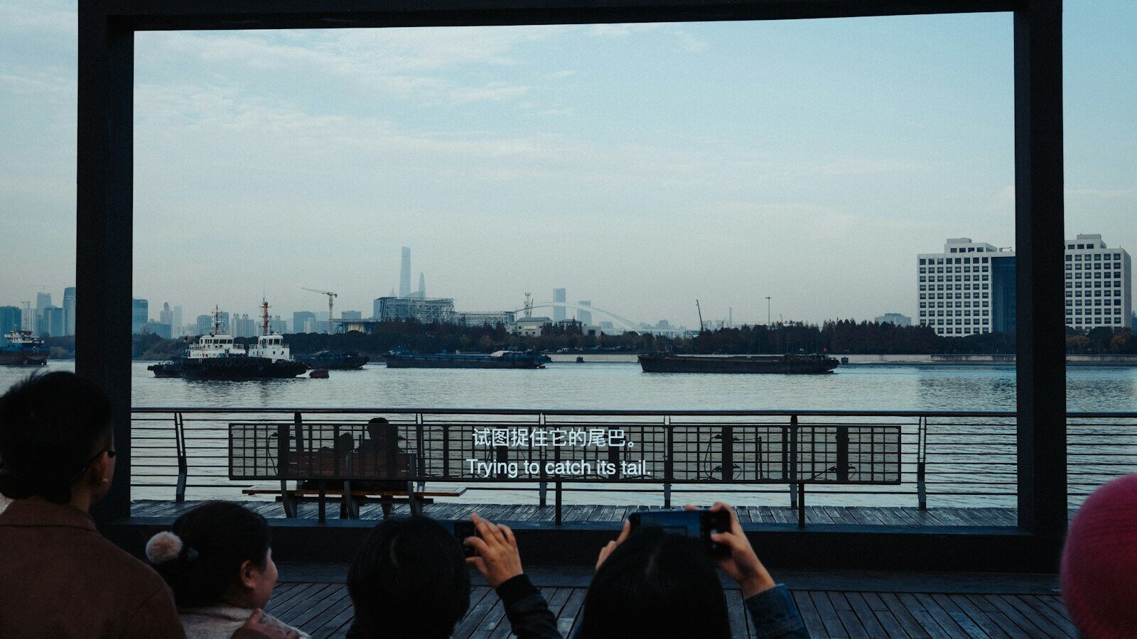 a group of people standing on top of a pier