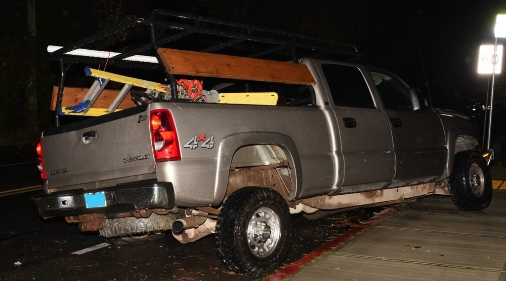 Grey 2003 Chevrolet Silverado 4x4 with a distinctive truck rack, shown in an official Saanich Police image released after the October 27 West Saanich Road collision.